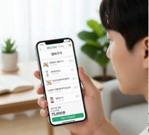 남성이 SSG닷컴 모바일 앱에서 이마트몰 장바구니 목록을 확인하고 있는 모습. 화면에는 '무항생제 계란', '깐마늘', '피코크 밀푀유나베 밀키트', '노브랜드 숯불데리야끼 닭꼬치', '생수(2L*6)' 등의 상품이 담겨 있으며, 총 상품 금액은 75,800원으로 표시되어 있다.