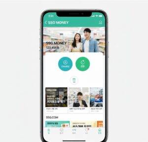SSG닷컴, SSG페이 앱의 SSG 머니 화면을 보여주는 스마트폰 목업 이미지. 화면 중앙에는 '충전'과 '전환' 버튼이 크게 강조되어 있으며, 현재 SSG 머니 잔액 '123,456원'이 표시되어 있다. 상단에는 마트에서 쇼핑하는 커플의 이미지가, 하단에는 SSG.COM의 다양한 프로모션 배너들이 보인다.
