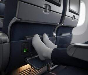 싱가포르 항공 이코노미 좌석 아래 3단 조절 발받침대에 발을 올리고 220v 콘센트에 충전기를 연결한 모습