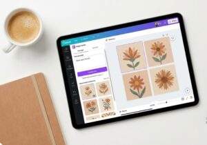 흰색 책상 위 태블릿 화면에 캔바 매직 미디어 툴이 열려 있고, 'Boho style flower'라는 텍스트 프롬프트에 따라 생성된 4가지 꽃 일러스트가 보이는 플랫레이 사진. 옆에는 커피와 노트가 있음.